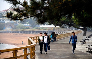 People visit Taipingjiao Park in Qingdao, E China